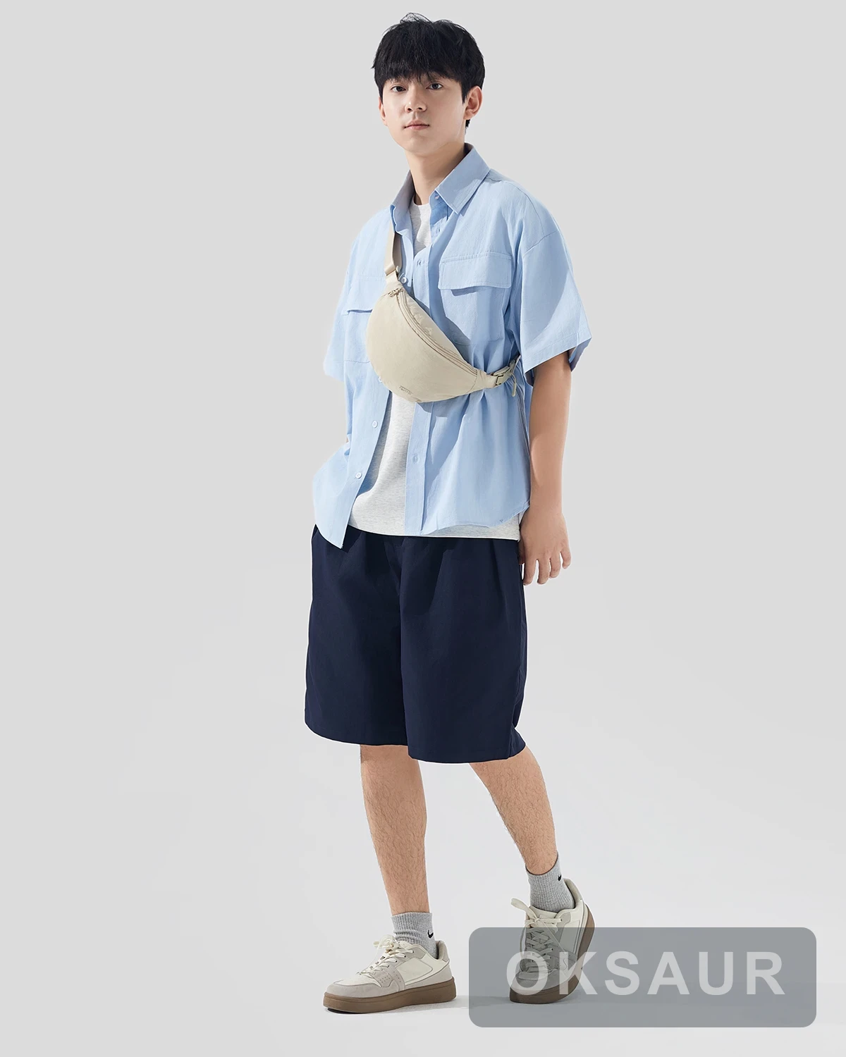 Cream crescent shoulder bag worn across the body