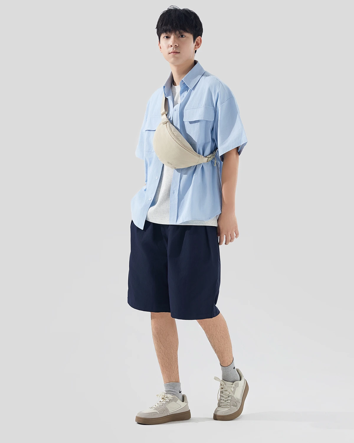 Cream MG6002 crescent shoulder bag worn across the body