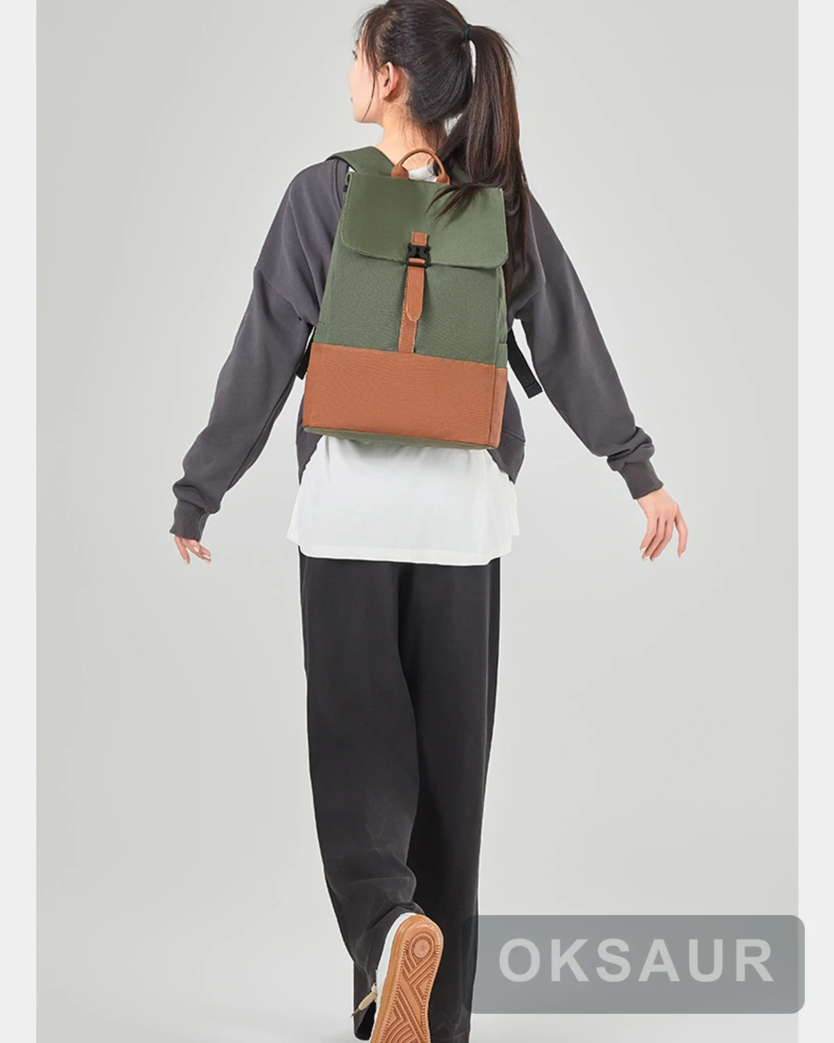 Two-tone canvas travel backpack shown from the rear