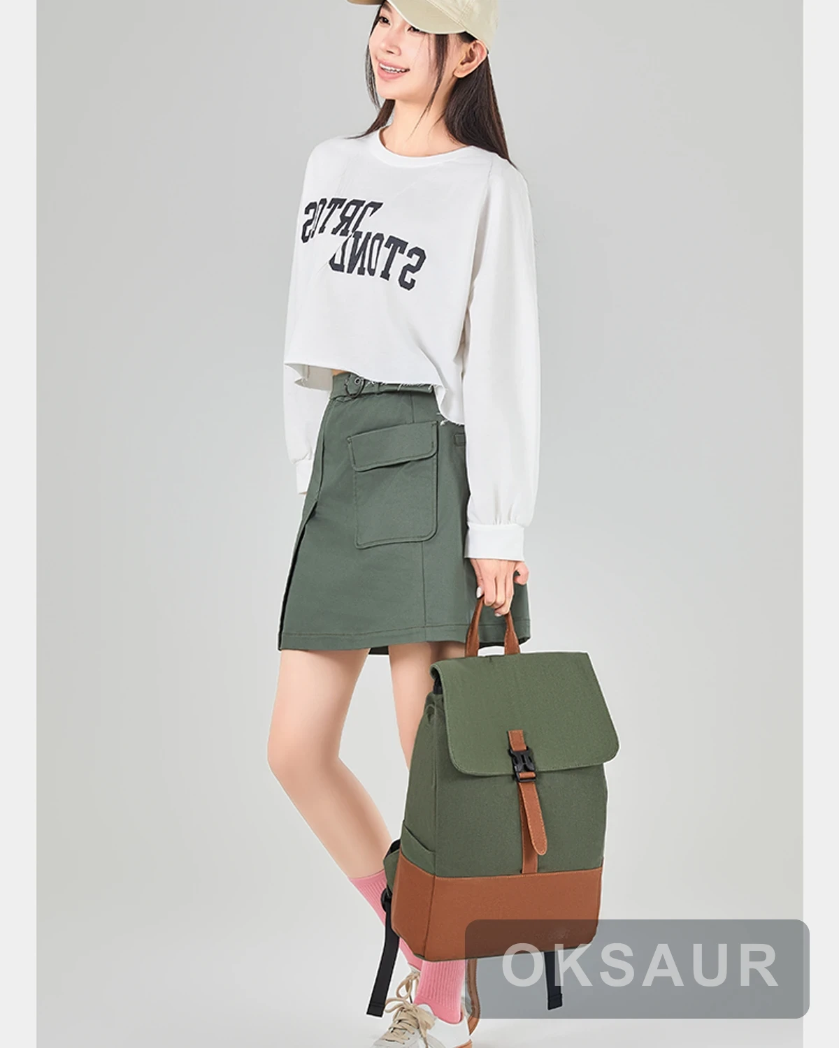 Two-tone canvas travel backpack carried by a model
