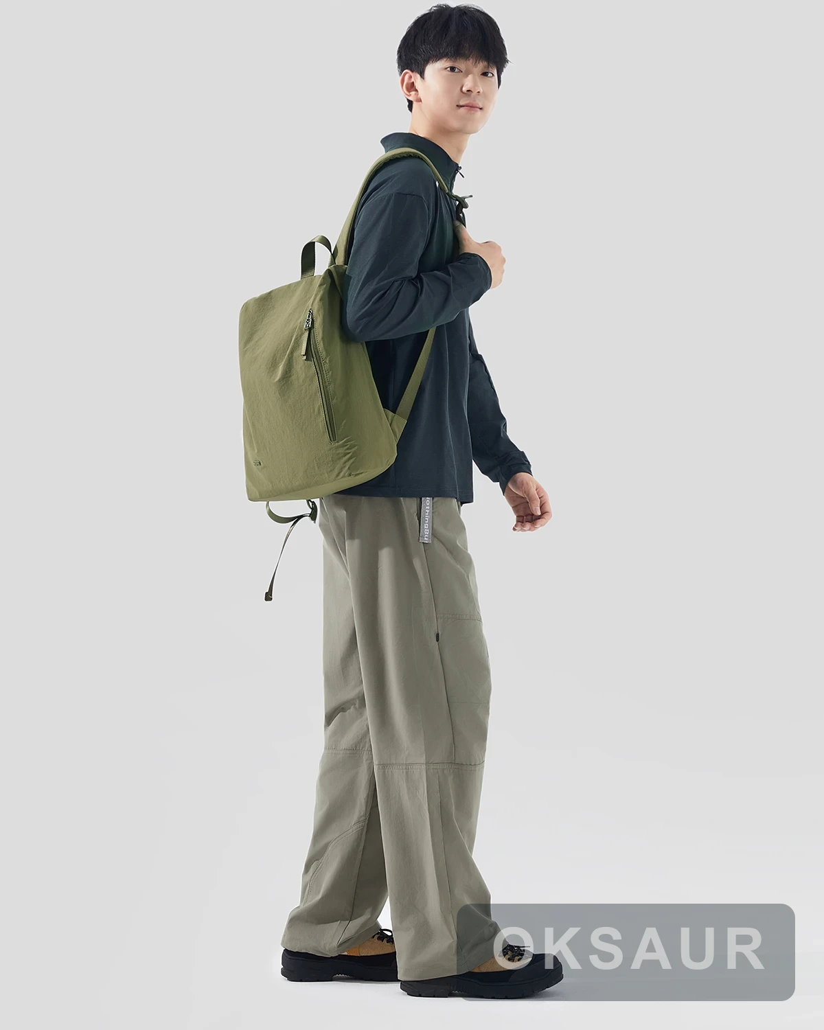 Olive lightweight backpack worn on one shoulder