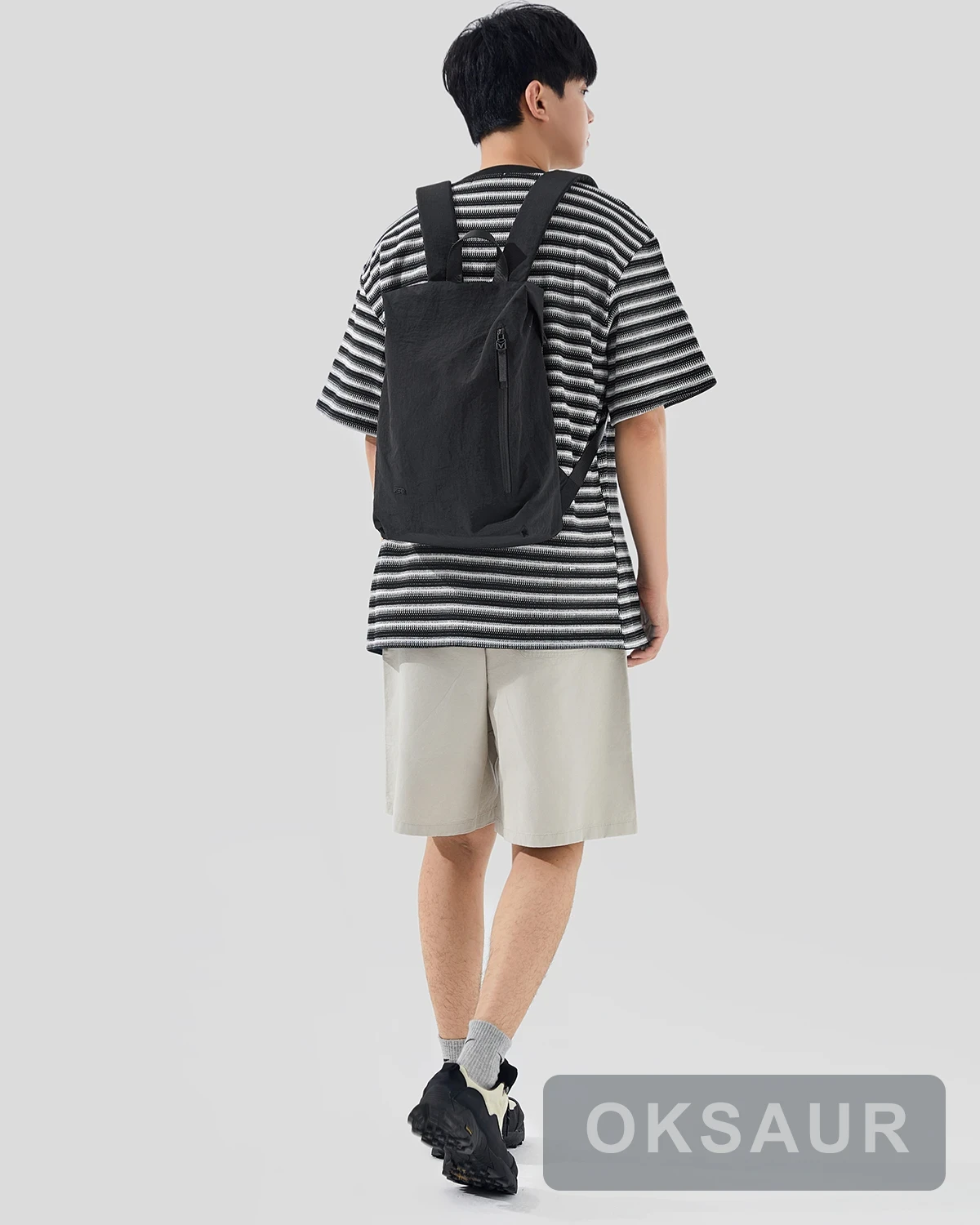Black lightweight backpack worn from the rear