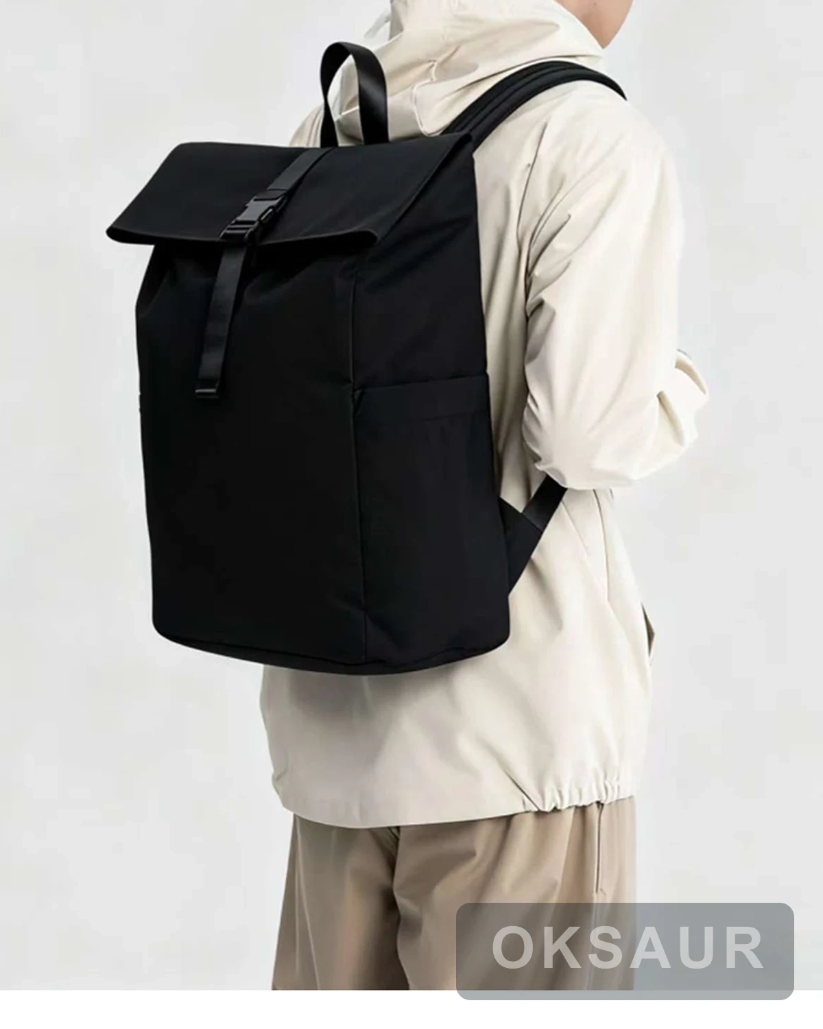 Black roll-top commuter backpack worn on a model